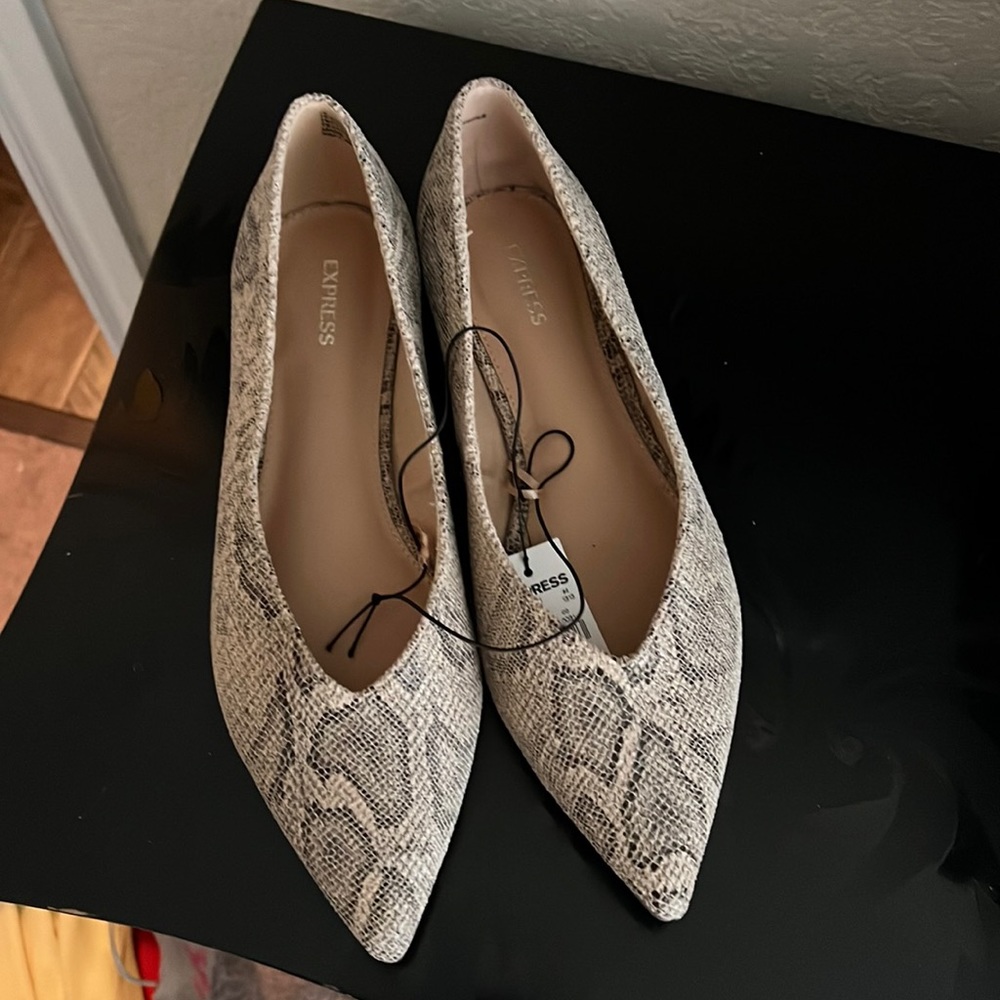 Brand New. Never worn. Snakeskin flats. Size 10